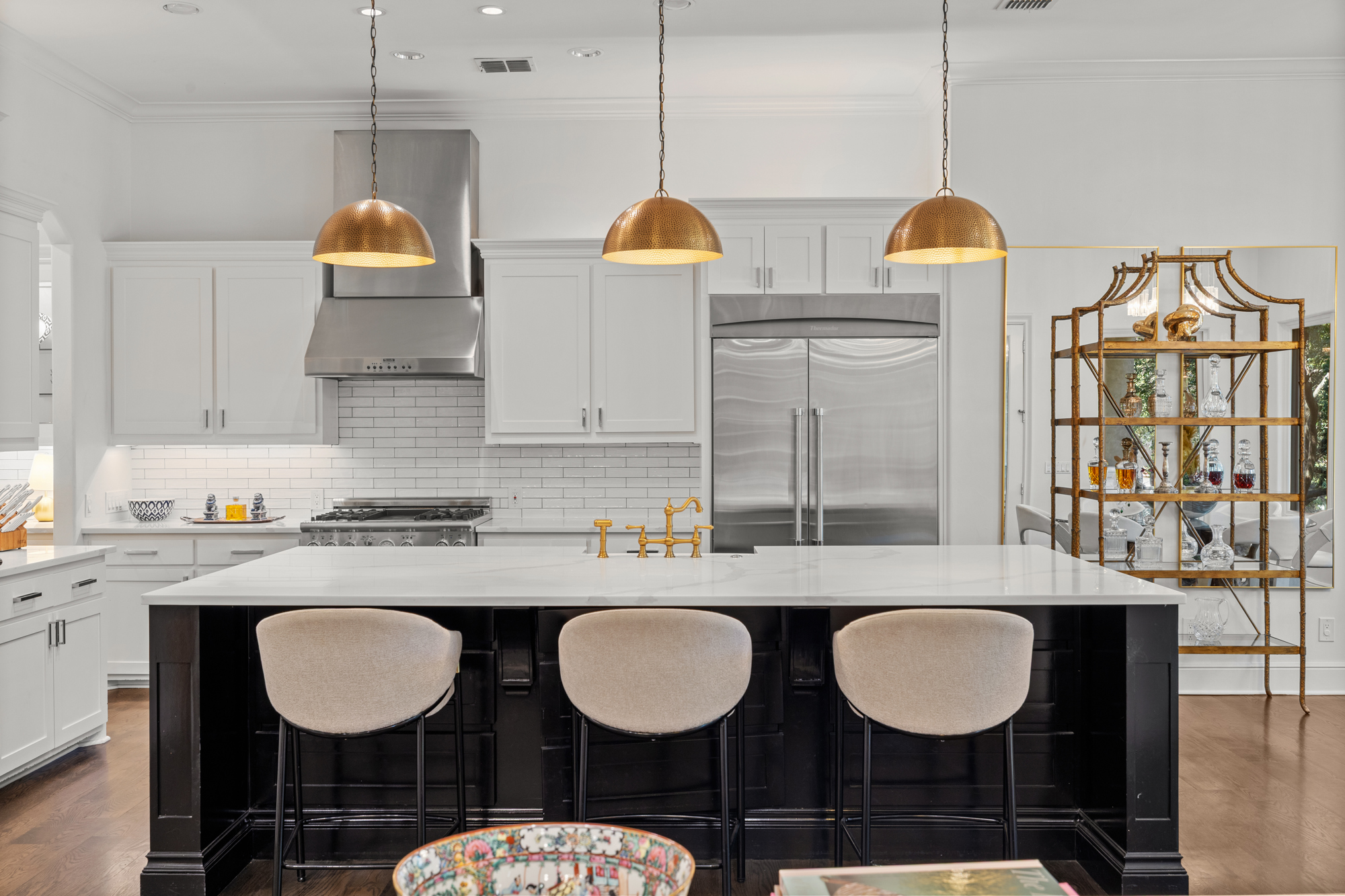 Designer kitchen with marble island and copper pendant lights in DFW luxury home