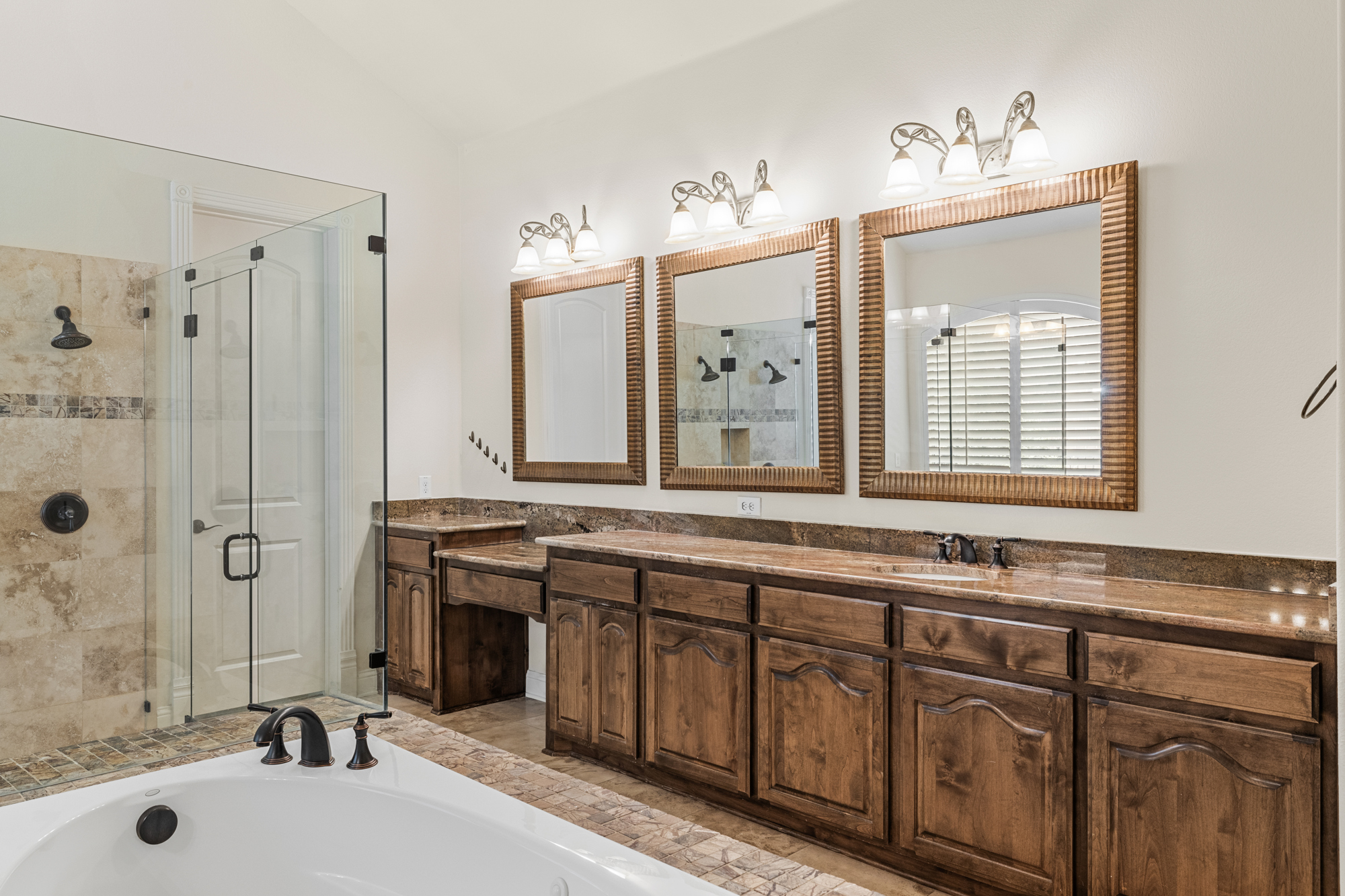 Luxury master bathroom with soaking tub and dual vanity in DFW estate