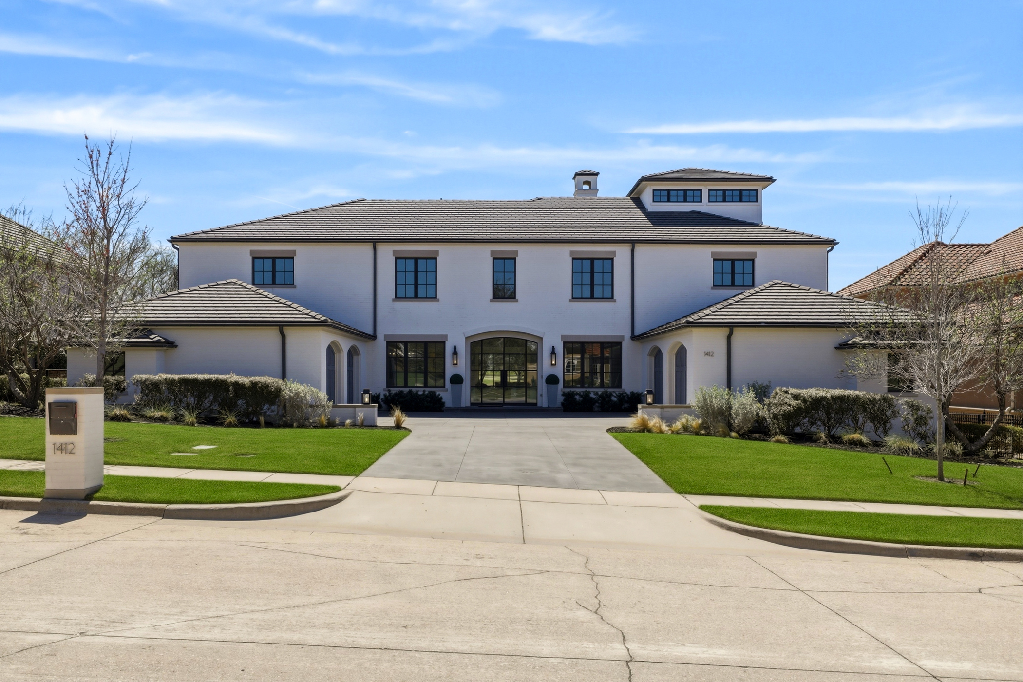 Luxury home with lush landscaping in DFW community