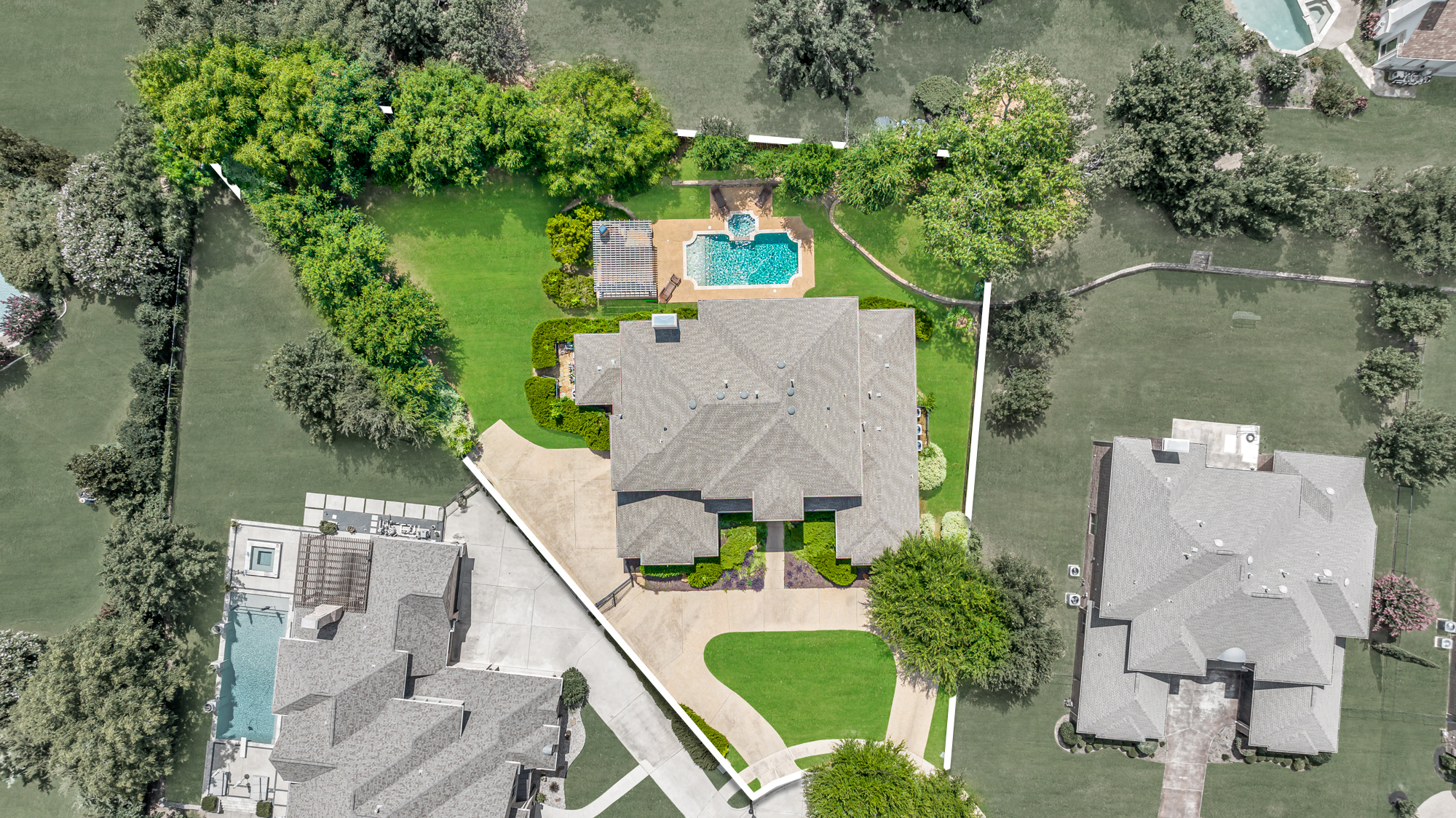 Aerial view of luxury Southlake neighborhood with pool and mature trees