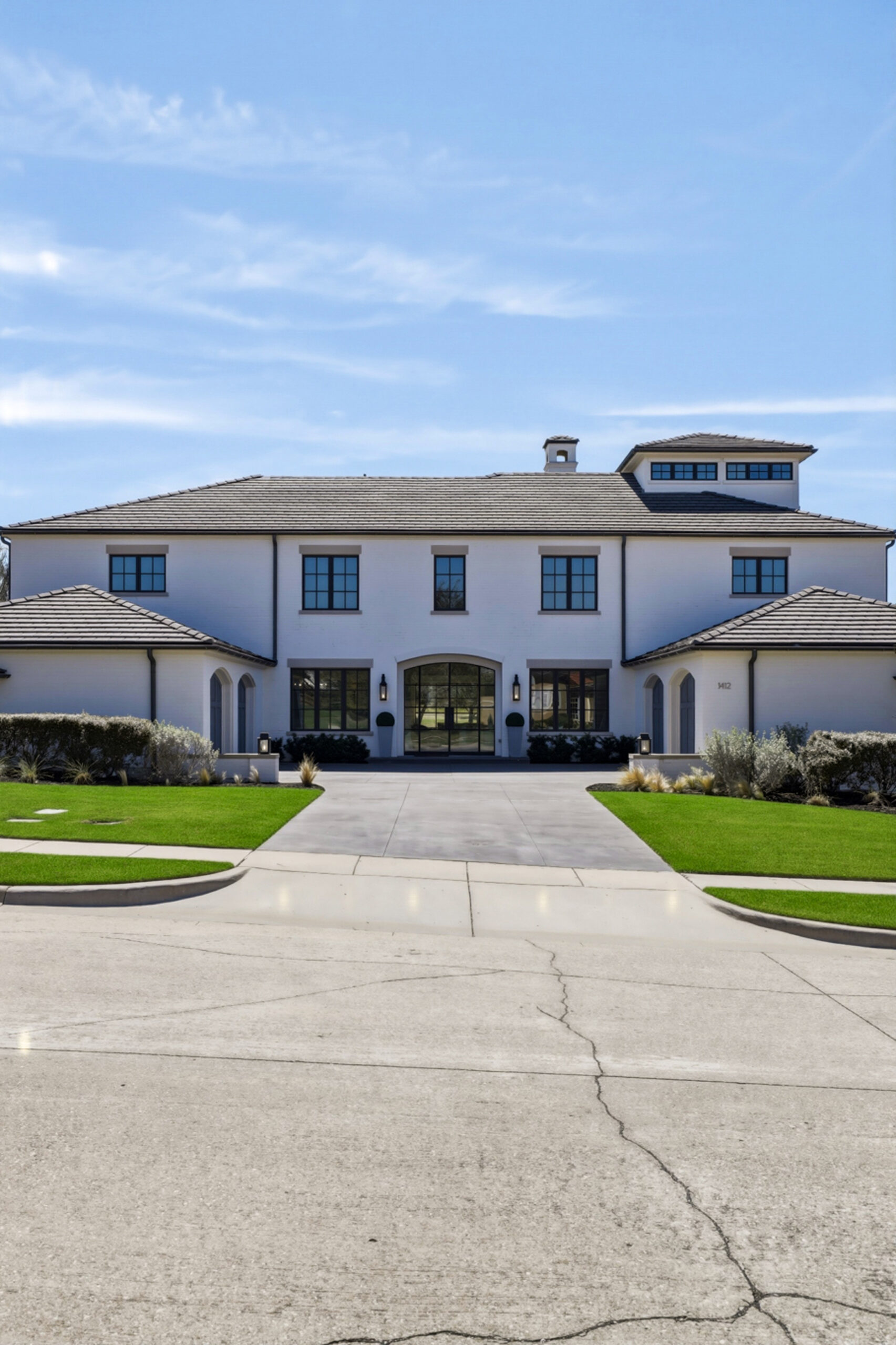 Southlake estate with manicured lawn and stone facade