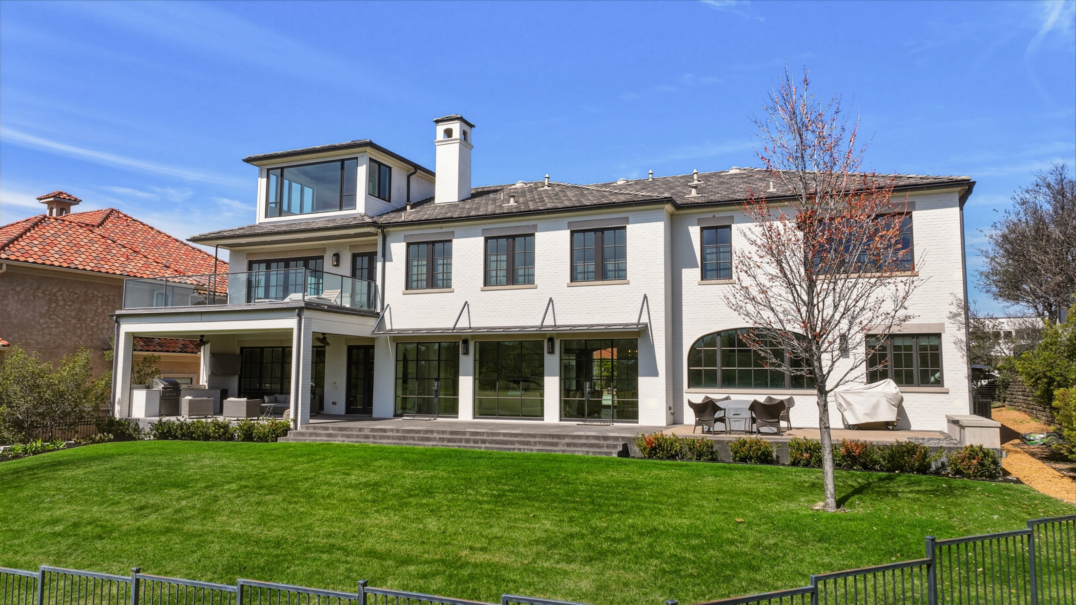 Modern white brick estate with expansive backyard in Southlake TX